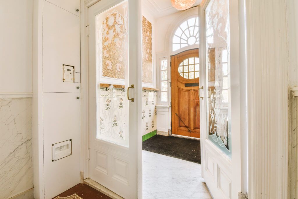 Main entryway shows charm and history with a cozy, old-style front door.