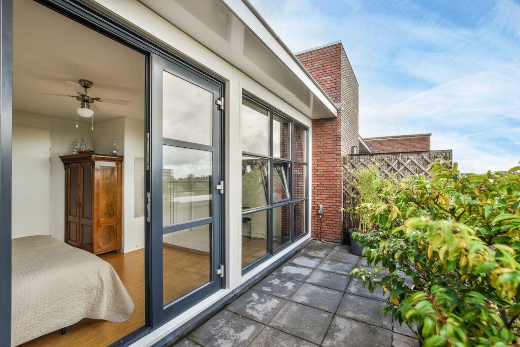 Sliding glass door opens to a quiet patio with garden views.