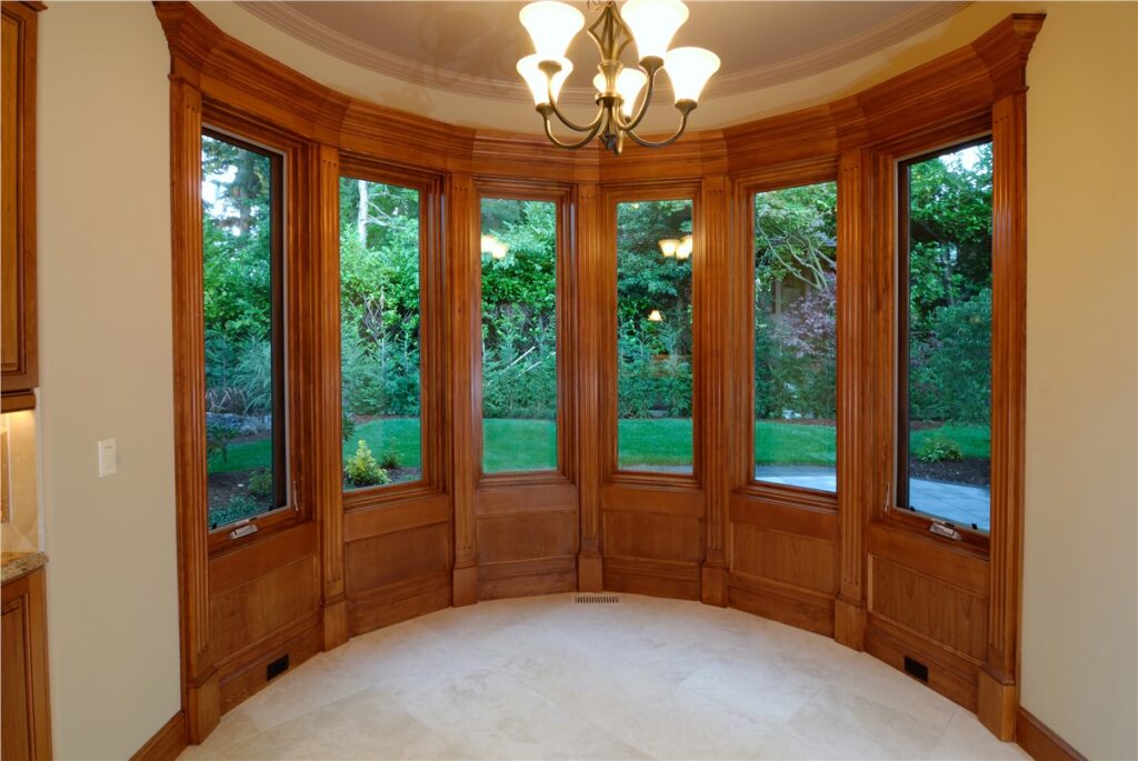 A bow window curves gently outward, giving wide outdoor views and making the room feel open and inviting.