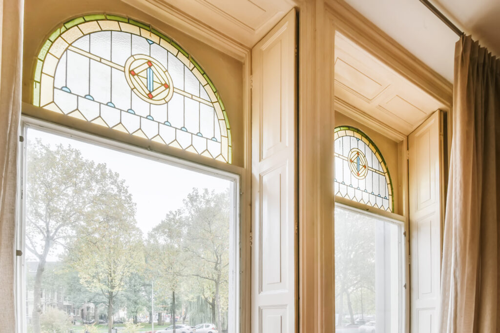 Tall windows brighten the room while adding style and quiet privacy to the space.