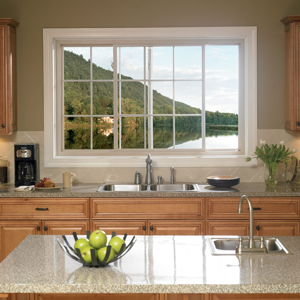 A sliding window above the sink lets in natural light and fresh air while offering a clear outdoor view.