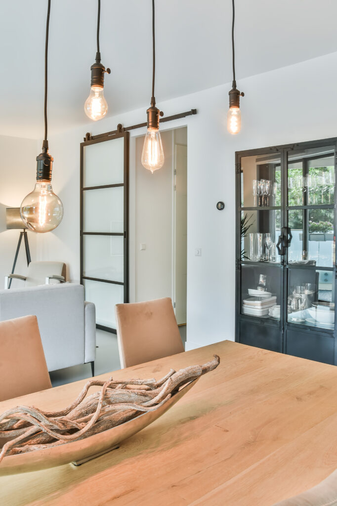 Modern sliding door adds a clean, stylish touch between living and dining areas.